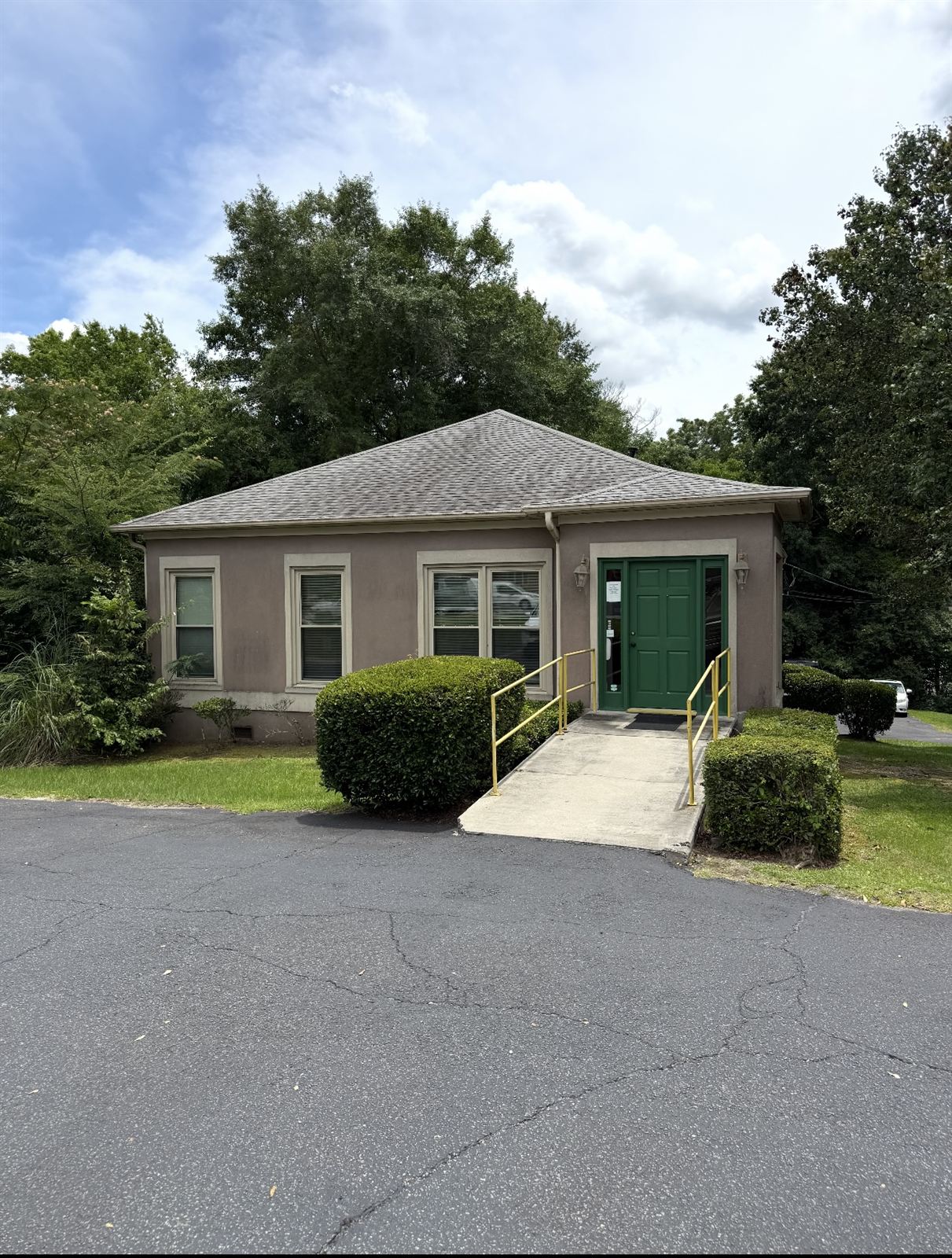 Office building with a dull, dirty roof before exterior washing in Columbus, GA