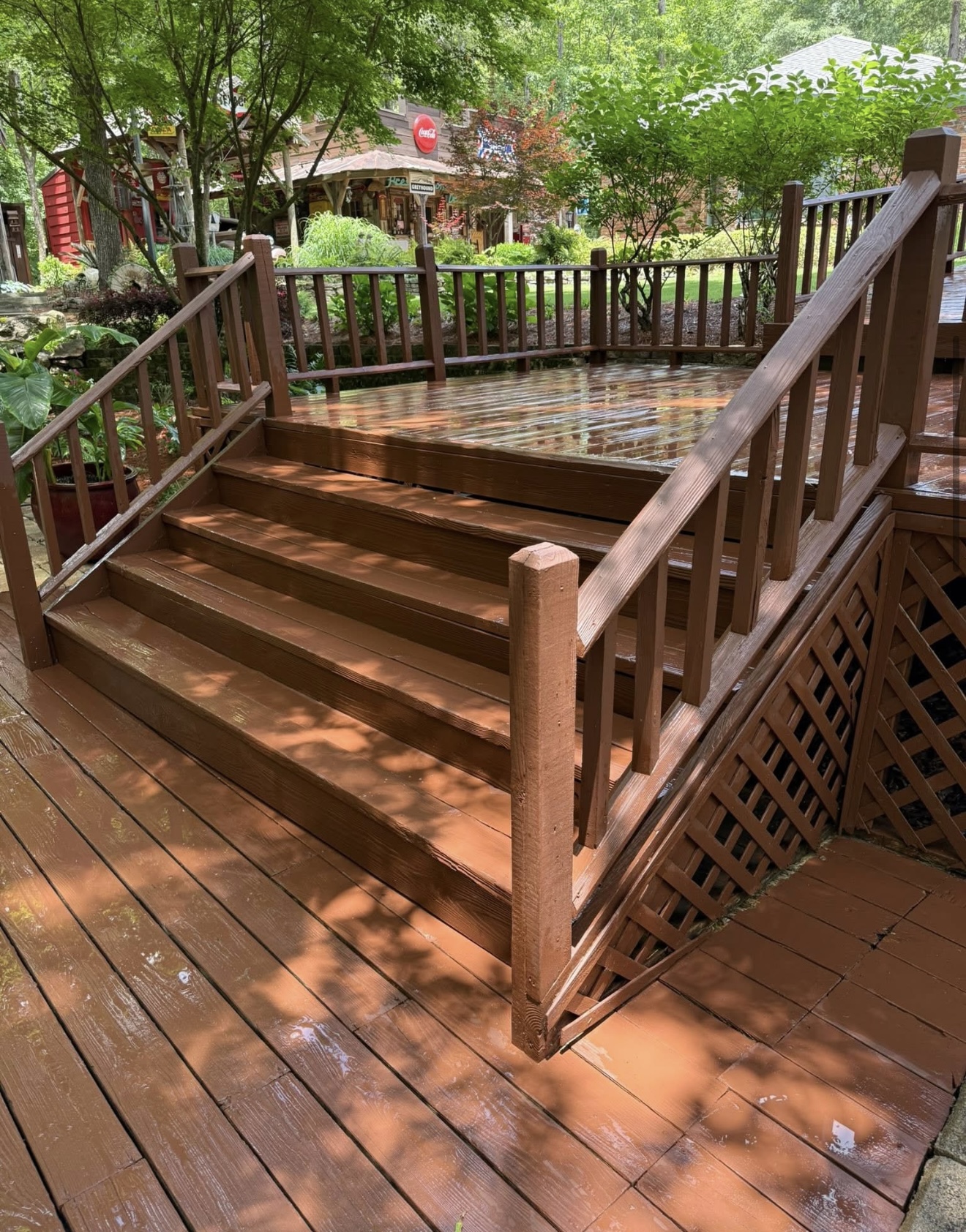 Restored warm-brown wood deck and stairs after pressure washing in Columbus, GA
