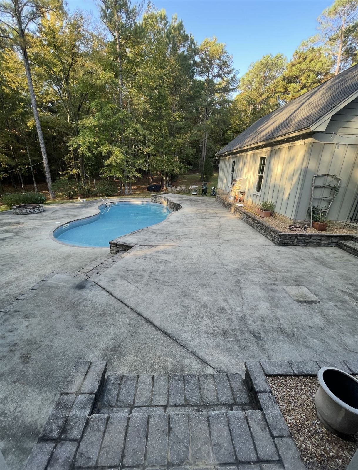 Gray, dingy pool deck concrete before pressure washing in Columbus, GA