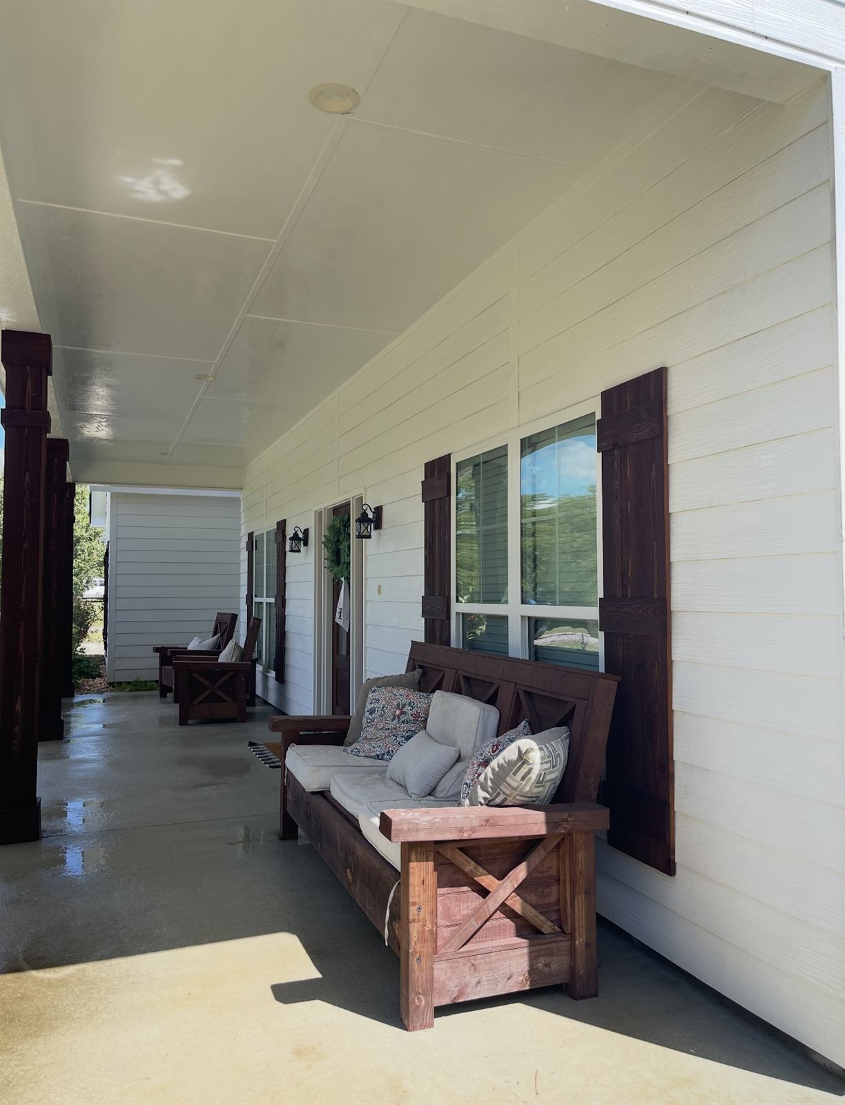 Bright white porch ceiling and siding after a soft wash in Columbus, GA