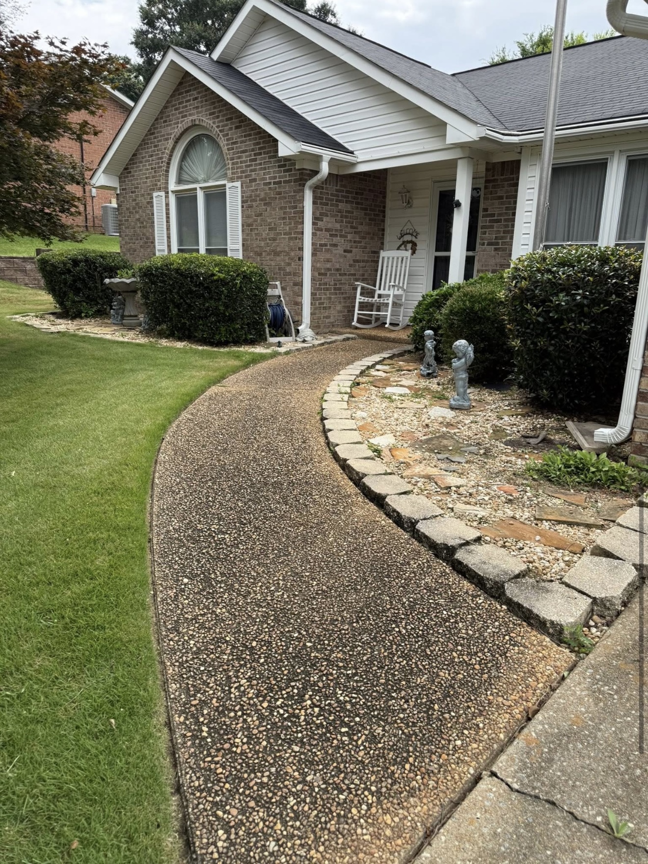 Dirty darkened aggregate walkway before pressure washing in Columbus, GA
